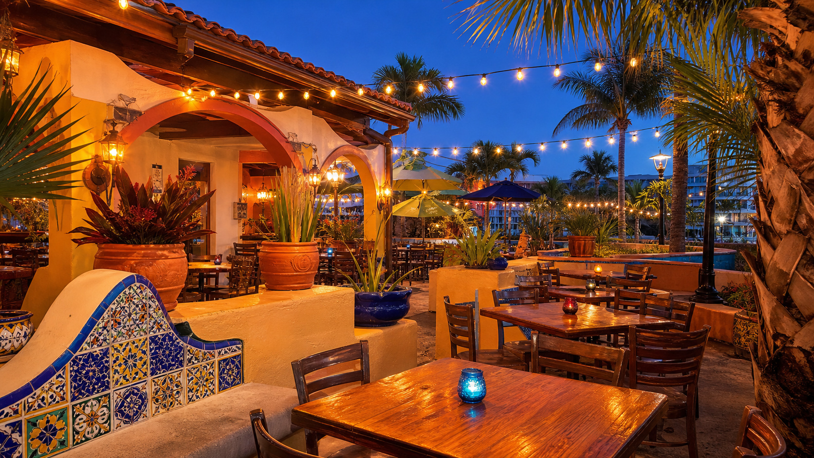 Casual Mexican restaurant patio near Miramar Beach Florida with string lights and outdoor seating at dusk, beach-town atmosphere