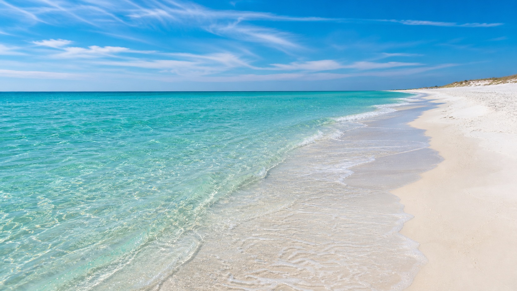 Vivid emerald-green and turquoise Gulf of Mexico water on Destin Florida's white quartz sand beach