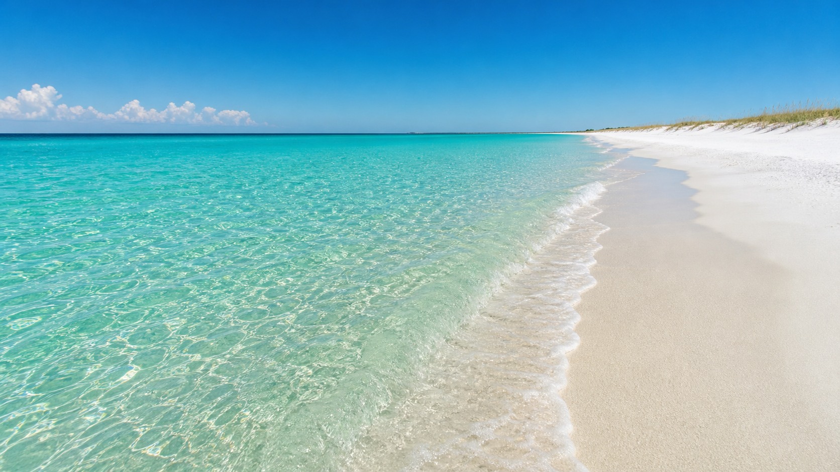 Crystal-clear emerald green Gulf of Mexico water meeting white quartz sand beach in Destin Florida on a sunny summer day